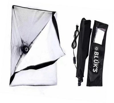 Photography softbox, umbrella, and carrying case on a white background