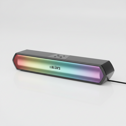 A BLUK'S brand rectangular RGB LED light bar or soundbar speaker, featuring a black casing and a vibrant gradient light strip showing red, orange, yellow, green, blue, and purple colors, resting on a dark reflective surface.
