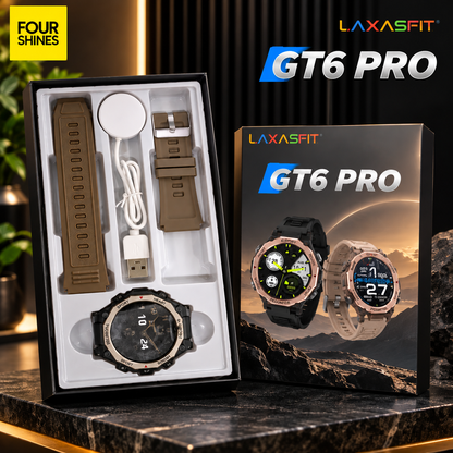 LAXASFIT GT6 Pro smartwatch shown with its retail box and included accessories on a dark marble surface. The watch has a round black face with a metallic bezel, displayed alongside two interchangeable brown bands, a white charging cable, and a wireless charging pad inside the open box.
