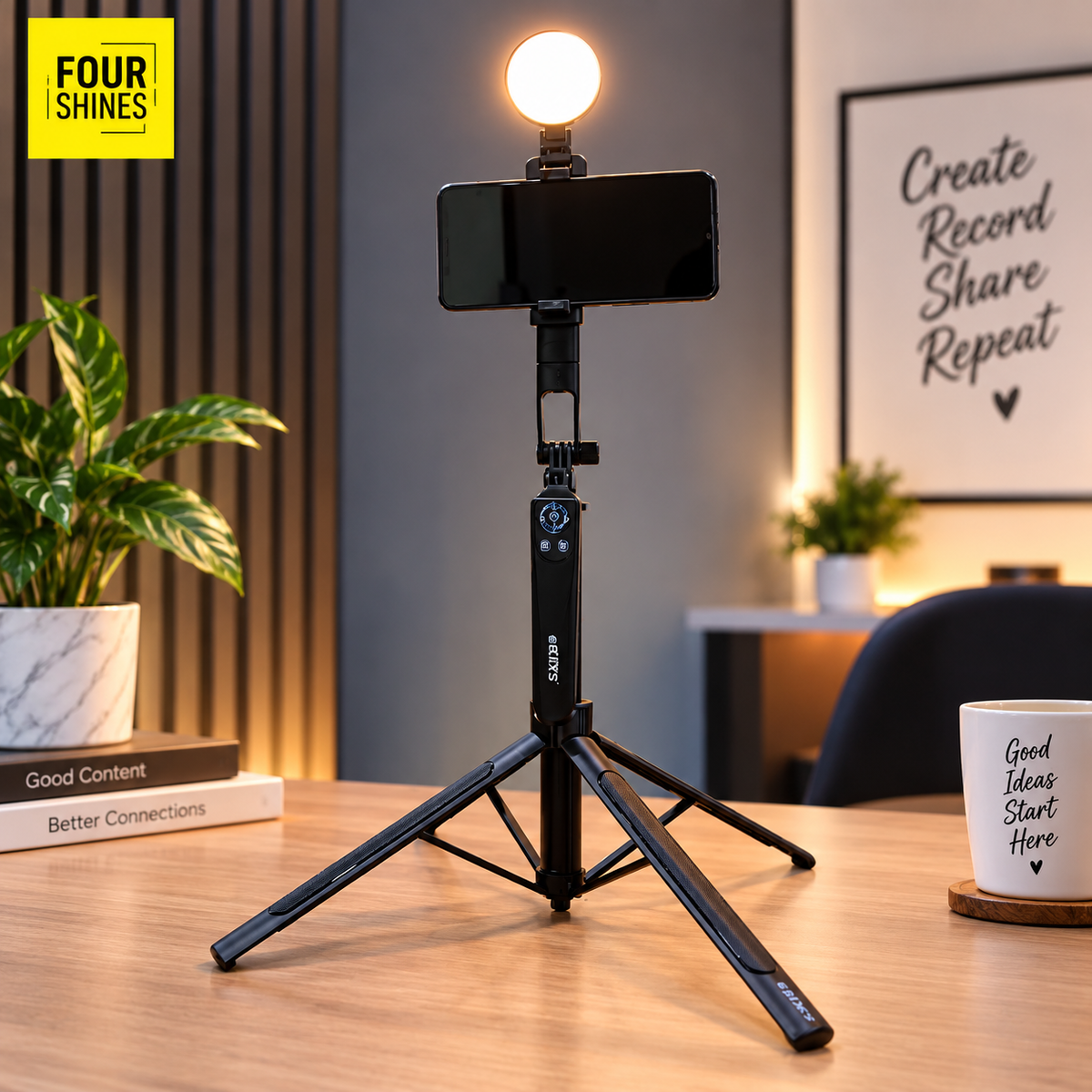 A black tripod selfie stabilizer with an attached smartphone and a glowing round light bulb on top, set on a wooden table in a modern room. A yellow 'FOUR SHINES' logo appears in the top-left corner.