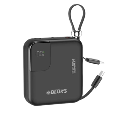 Black power bank with digital display and USB-C cable on a white background