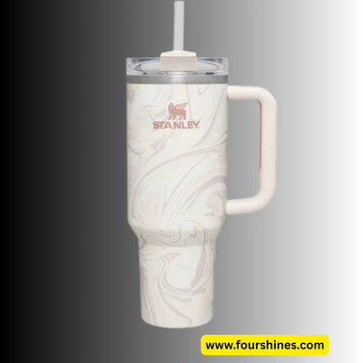 White marble-patterned tumbler with handle and straw lid, featuring Stanley logo, on gray background.