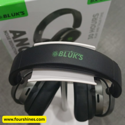 Black and green ear protection with 'BLUK'S' branding on a gray surface.