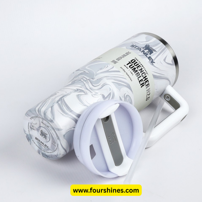 Marble-patterned tumbler with a white lid on a light gray background, featuring the brand 'Stanley'.