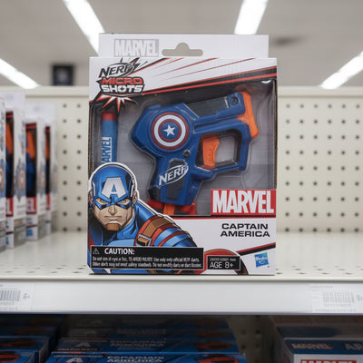 Nerf MicroShots Marvel Captain America Blaster in packaging, featuring red, white, and blue colors with Captain America branding.