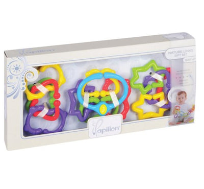A set of colorful baby rings in various shapes such as stars and hearts, packaged in an elegant white box with a clear window showing the rings and a baby image in the background.