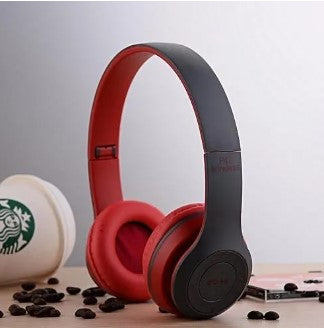 A pair of red P47 wireless Bluetooth headphones displayed next to its packaging box and a USB charging cable.