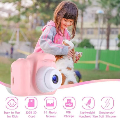 A child holding a blue digital camera with a 2.0 inch screen, displaying a smiling face on the screen.