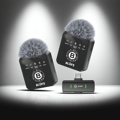 Two wireless microphone transmitters with BLöUK'S logo on a dark background