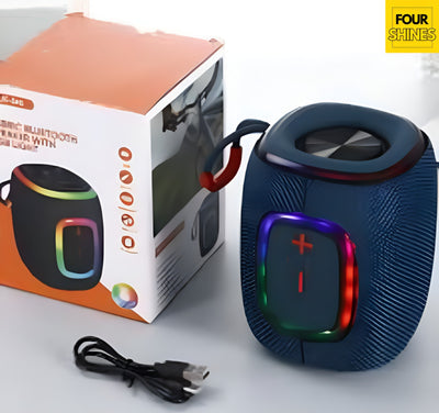 Blue Bluetooth speaker with colorful lights next to its packaging on a white background