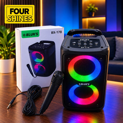 BLUK'S BX-178 portable speaker system shown with its retail box, microphone, and a yellow 'FOUR SHINES' badge, set against a modern living room background.