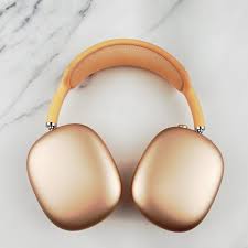 Gold-colored ear muffs on a marble surface