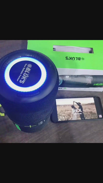 Black Bluetooth speaker with colorful lighting on a white background, featuring the Four Shines brand.
