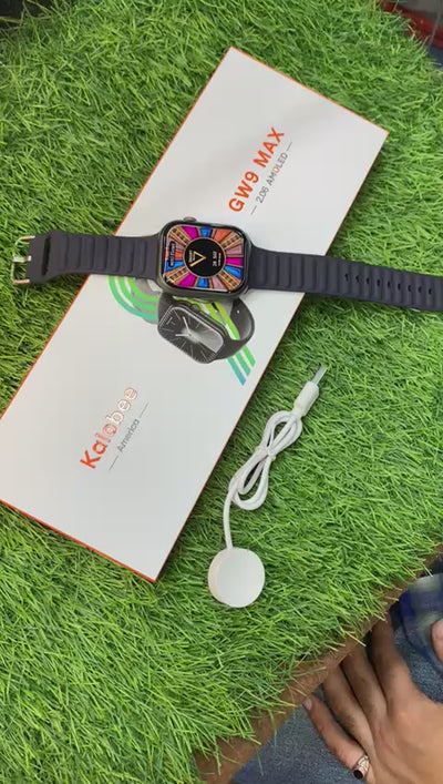 GW9 MAX smart watches with silicone bands in black, blue, and gray colors, displayed alongside their packaging.